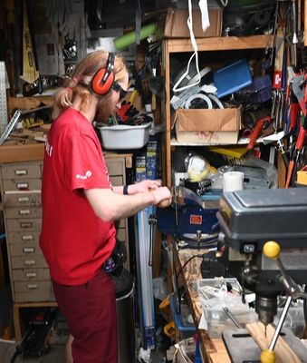 Patrick hammering the bracket in place