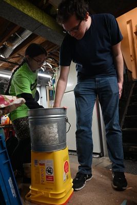 Grace and Zack measuring the cat feeder box