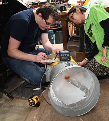 Grace and Zack measuring the cat feeder box